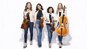 a photo of four women holding string instruments