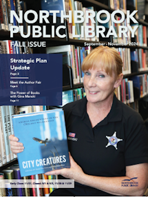 A photo of a woman holding a book at the library