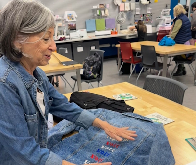 A photo of a patron with her upcycled jean jacket